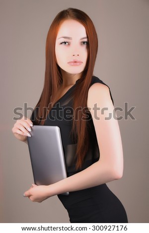 lady boss fashion portrait of Beautiful girl model with red hair.young business woman with tablet PC