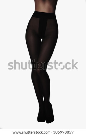 beautiful female legs in a tights.Young woman standing on one leg wearing high heels shoes