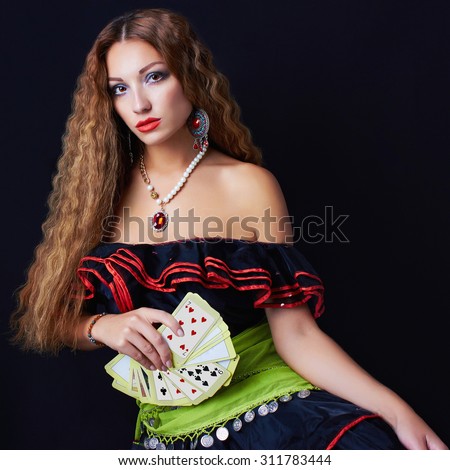 beautiful young woman fortune teller read the cards.halloween sexy gypsy girl
