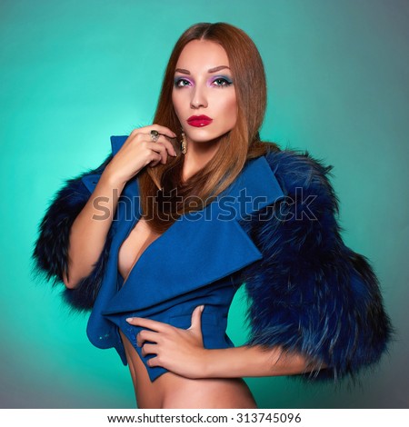 Beautiful young woman in blue fur.winter fashion.Beauty sexy Model Girl with healthy hair. Woman in Luxury Fur coat and jewelry