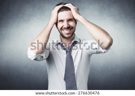bearded man confused with shirt on grey background