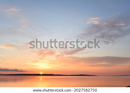 Сlouds lit by the sun setting over the horizon Photo stock © 