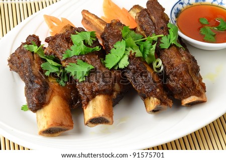 Close-up of pork ribs with sweet chili sauce