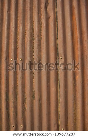 an old rusty damaged piece of metal roofing