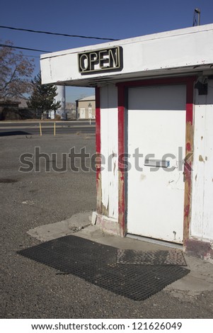 Door for a business with open neon sign. the door is closed.