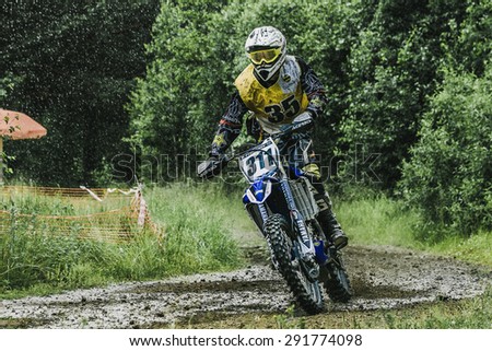 Kyshtym, Russia - June 21, 2015: Motocross driver on wet and muddy terrain competes during the race Urals Cup of Enduro \