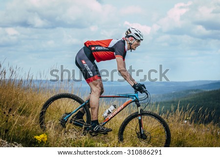 V.Ufaley, Russia - August 09, 2015: old racer on the mountain bike downhill during race \