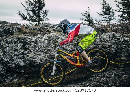 Magnitogorsk, Russia -  September 12, 2015: Athlete on a mountain bike is flying in a jump from a springboard during Urals Cup of downhill bike, Magnitogorsk, Russia -  September 12