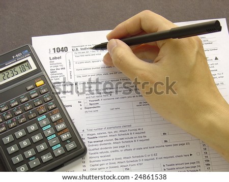 Filing tax on federal tax form with a calculator