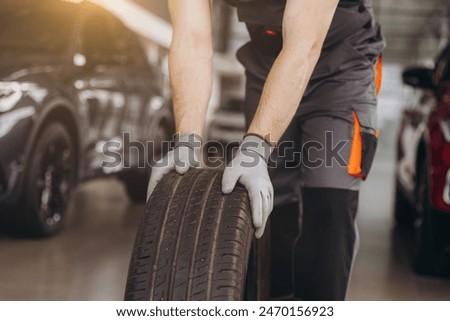 Similar – Image, Stock Photo Bearded mechanic repairing wheel of bicycle