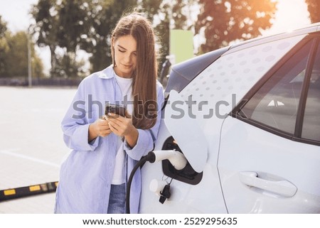 Similar – Image, Stock Photo Woman holding a charging cable in her hand