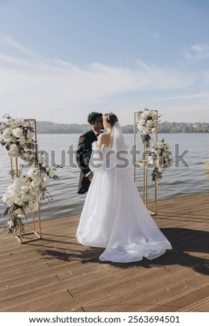 Similar – Image, Stock Photo Newlywed couple kissing during romantic travel