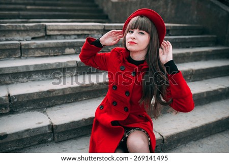 girl in red coat on the stairs