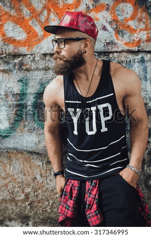 young handsome fashion bearded model man in urban context