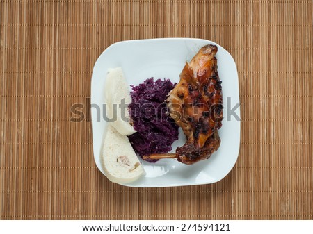 rabbit meat roaster with onion cumin and garlic on wooden vintage table with cabbage and dumpling