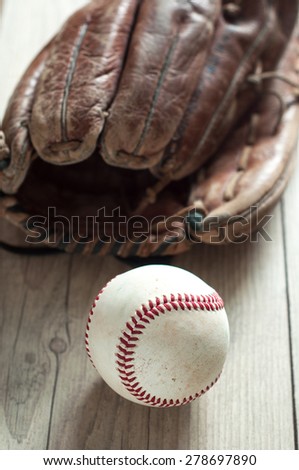 Old and worn used leather baseball sport glove over aged