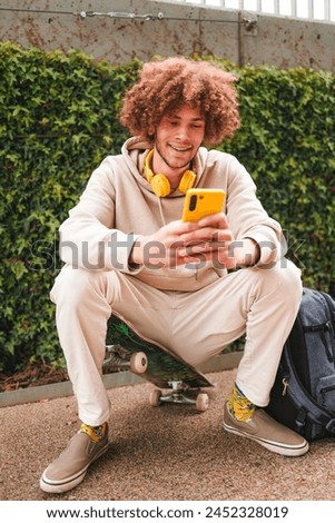 Similar – Foto Bild Entspannter männlicher Skater beim Musikhören in der Stadt