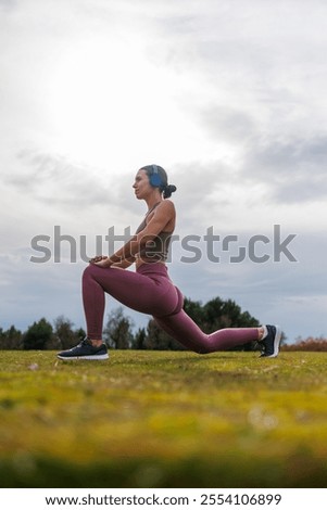 Similar – Image, Stock Photo Sportswoman stretching legs on stadium