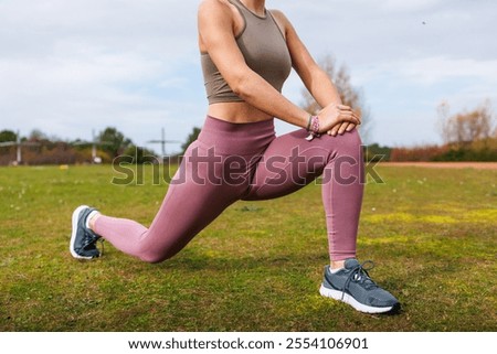 Similar – Image, Stock Photo Sportswoman stretching legs on stadium