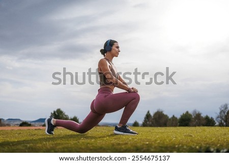 Similar – Image, Stock Photo Sportswoman stretching legs on stadium