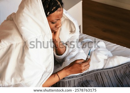Similar – Image, Stock Photo Sick woman checking body temperature near window at home