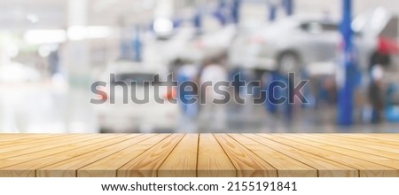 Empty wood table top with car service centre auto repair workshop blurred background Foto stock © 