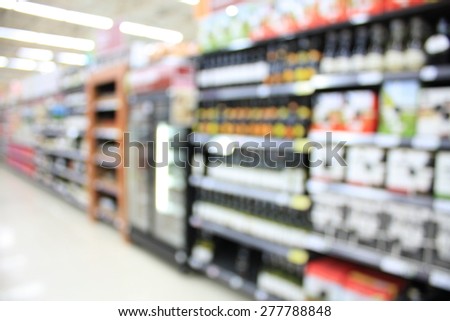 wine shelves in supermarket blurry for background