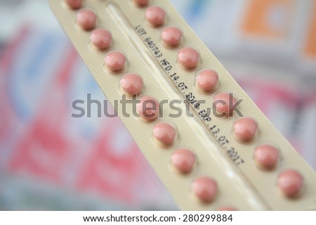 oral contraceptive pill in pharmacy drugstore with medicine blur background
