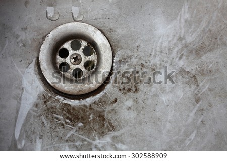 Drain hole in a dirty sink close up