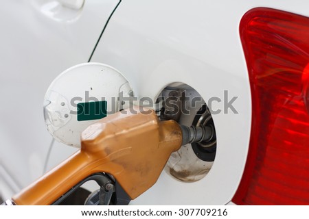 To fill the machine with fuel. Car fill with gasoline at a gas station. Gas station pump.Car gas fill up.