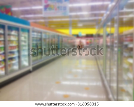 Supermarket Aisle Milk Yogurt Frozen Food Freezer and Shelves blurred background