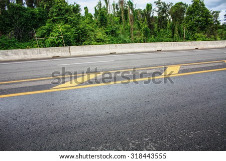 Asphalt road texture background with yellow dashed line