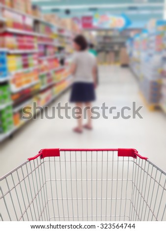 female shopping in supermarket with shopping cart