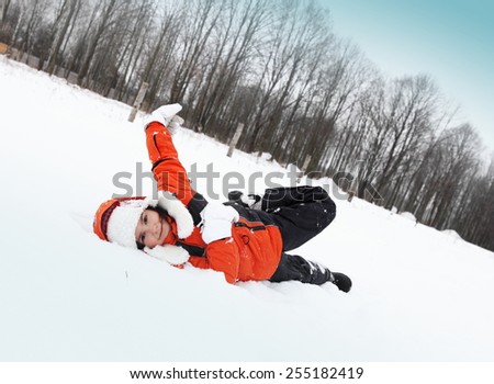 Little Girl Playing with Snow Outdoors in Winter