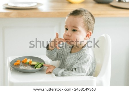 Similar – Image, Stock Photo Child eating fresh carrot