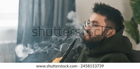 Similar – Image, Stock Photo Adult man smoking while looking at camera during sunset