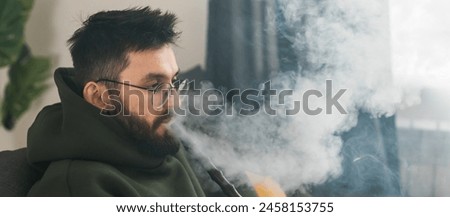 Similar – Image, Stock Photo Adult man smoking while looking at camera during sunset