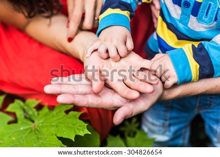 Mom and Dad hold baby\'s hand,  Family walk in the park