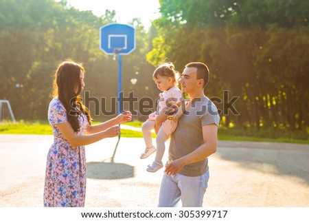 Happy Young Mixed Race Ethnic Family Walking In The Park.