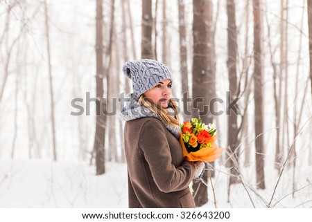 Winter woman with bouquet of flowers. portrait outdoor