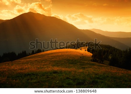sun rays over the misty hills and light in mountain valley
