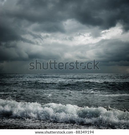 dark storm clouds and waves on the sea