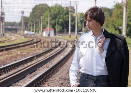 young businessman walking near the railroad