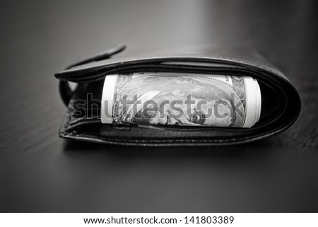 Purse with the big pack of dollars