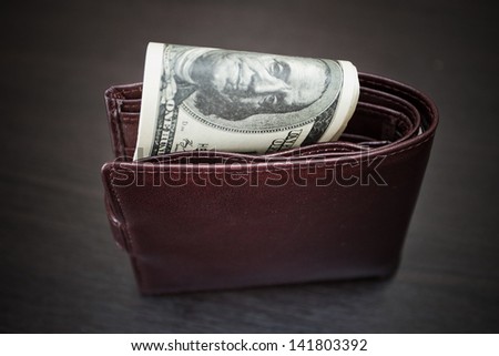 Purse with the big pack of dollars