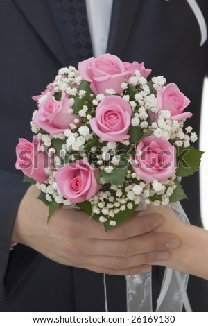 Rose flowers wedding bouquet, hands of bride and groom, traditional black and white wedding dress