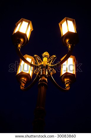Four-horned luminous street lantern at night
