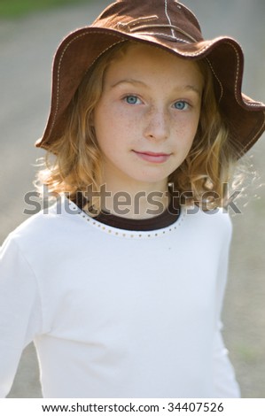 pretty ten year old girl in a floppy brown sun hat