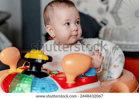 Image, Stock Photo 6 month old baby playing wearing black and white playing with colorful ring stack toy