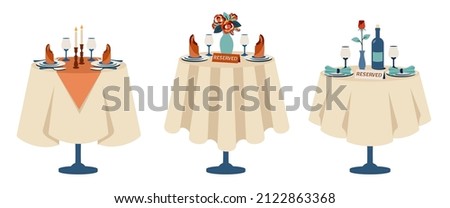 Set of reserved tables for two. Beautiful romantic dinner. Romantic setting. Table with white tablecloth, cutlery, glasses, bottle of wine, bouquet of flowers, rose, candles in candlesticks, napkins
